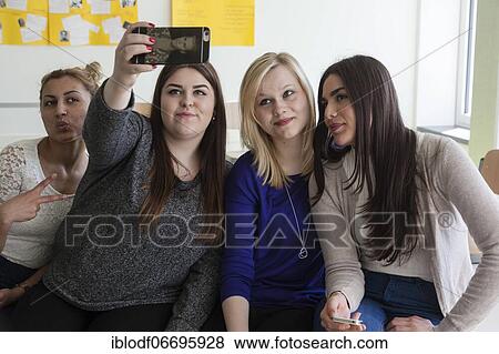 Stock Photo - Vocational school students with their smartphones during break at the Elly-Heuss-Knapp-Schule, a vocational college of the city of Düsseldorf, North Rhine-Westphalia, Germany, Europe. Fotosearch