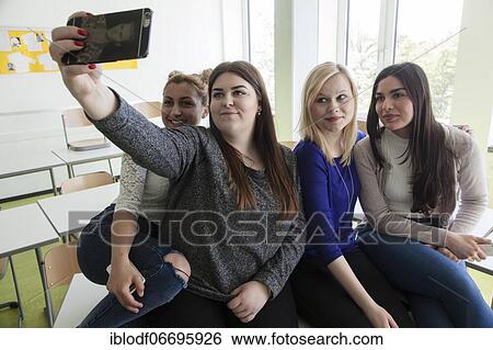 Vocational school students with their smartphones during break at the Elly-Heuss-Knapp-Schule, a vocational college of the city of Düsseldorf, North Rhine-Westphalia, Germany, Europe View Large Photo Image Stock Photograph - Vocational school students with their smartphones during break at the Elly-Heuss-Knapp-Schule, a vocational college of the city of Düsseldorf, North Rhine-Westphalia, Germany, Europe. Fotosearch