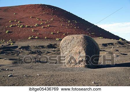 Vulcanic bomb, near the walking path around the Montana Colorada, Parque de los Volcanes, Lanzarote, Canary Islands, Spain, Europe View Large Photo Image Stock Photo - Vulcanic bomb, near the walking path around the Montana Colorada, Parque de los Volcanes, Lanzarote, Canary Islands, Spain, Europe. Fotosearch