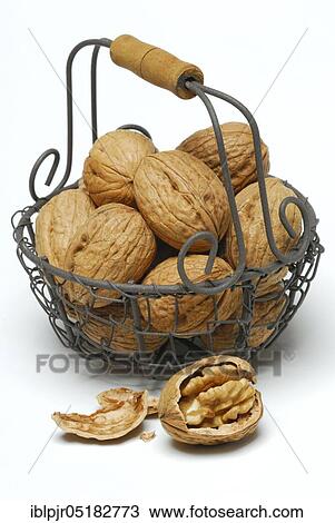 Stock Image - Walnuts (Juglans regia) in basket. Fotosearch