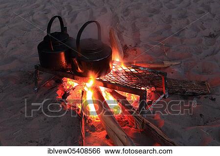 Stock Photograph - Water jug, fireplace, hotel, campfire, Okavango Delta, Botswana, Africa. Fotosearch