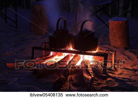 Stock Photography - Water jug, fireplace, hotel, campfire, Okavango Delta, Botswana, Africa. Fotosearch