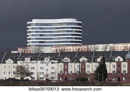 White office tower by SOP Architekten, Trivago Tower, old residential buildings in front, stormy sky, Düsseldorf Media Harbour, Düsseldorf, North Rhine-Westphalia, Germany, Europe View Large Photo Image Stock Image - White office tower by SOP Architekten, Trivago Tower, old residential buildings in front, stormy sky, Düsseldorf Media Harbour, Düsseldorf, North Rhine-Westphalia, Germany, Europe. Fotosearch