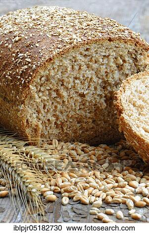 Stock Image - Wholemeal bread, sliced, wheat grains (Triticum spec. ), bread. Fotosearch