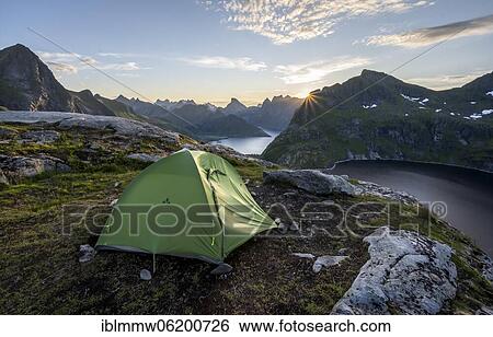 Wild camping with tent, sun shining over mountain landscape with fjord and lake Krokvatnet, Moskenesöy, Lofoten, Nordland, Norway, Europe View Large Photo Image Stock Photograph - Wild camping with tent, sun shining over mountain landscape with fjord and lake Krokvatnet, Moskenesöy, Lofoten, Nordland, Norway, Europe. Fotosearch