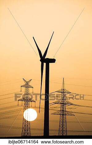 Wind turbine and power pole at sunset, Niederaussem, North Rhine-Westphalia, Germany, Europe View Large Photo Image Picture - Wind turbine and power pole at sunset, Niederaussem, North Rhine-Westphalia, Germany, Europe. Fotosearch