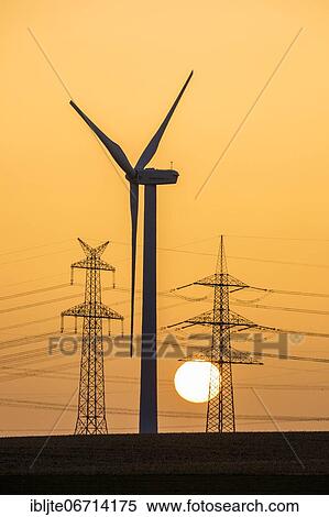 Wind turbine and power pole at sunset, Niederaussem, North Rhine-Westphalia, Germany, Europe View Large Photo Image Stock Photography - Wind turbine and power pole at sunset, Niederaussem, North Rhine-Westphalia, Germany, Europe. Fotosearch