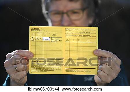 Woman proudly showing her vaccination certificate after being vaccinated with AstraZeneca against Covid-19, Sars-CoV-2, Corona crisis, Stuttgart, Baden-Württemberg, Germany, Europe View Large Photo Image Picture - Woman proudly showing her vaccination certificate after being vaccinated with AstraZeneca against Covid-19, Sars-CoV-2, Corona crisis, Stuttgart, Baden-Württemberg, Germany, Europe. Fotosearch