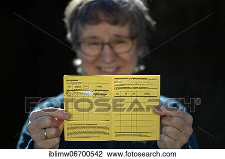 Woman proudly showing her vaccination certificate after being vaccinated with AstraZeneca against Covid-19, Sars-CoV-2, Corona crisis, Stuttgart, Baden-Württemberg, Germany, Europe View Large Photo Image Stock Image - Woman proudly showing her vaccination certificate after being vaccinated with AstraZeneca against Covid-19, Sars-CoV-2, Corona crisis, Stuttgart, Baden-Württemberg, Germany, Europe. Fotosearch