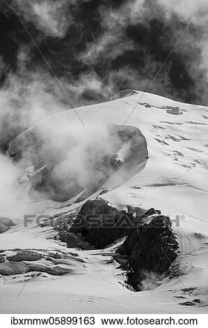 Stock Image - Black and white, high alpine mountain landscape, Dôme du Goûter summit with glacier, Chamonix, Haute-Savoie, France, Europe. Fotosearch