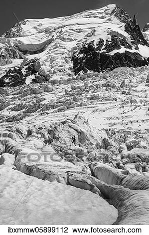 Stock Image - Black and white, La Jonction, glacier tongue, Glacier des Bossons meets Glacier de Taconnaz, summit of Mont Maudit, Mont Blanc and Aiguille de Bionnassay, Chamonix, Haute-Savoie, France, Europe. Fotosearch