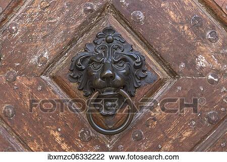 Stock Image - Brass lion head as a door knocker on a historical entrance gate, Bamberg, Upper Franconia, Bavaria, Germany, Europe. Fotosearch