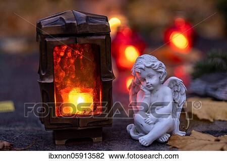 Burning grave light and angel figure on a grave, Germany, Europe View Large Photo Image Stock Image - Burning grave light and angel figure on a grave, Germany, Europe. Fotosearch