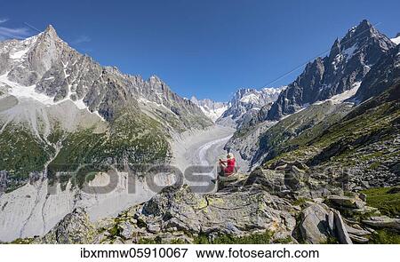 Stock Photo - Climber on hiking trail, Grand Balcon Nord, glacier tongue Mer de Glace, behind Grandes Jorasses, Mont Blanc massif, Chamonix, France, Europe. Fotosearch