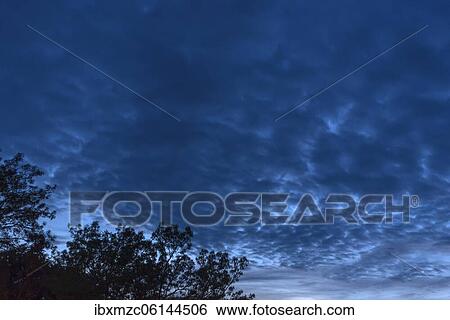 Stock Photograph - Cloudy sky at the blue hour, Bavaria, Germany, Europe. Fotosearch