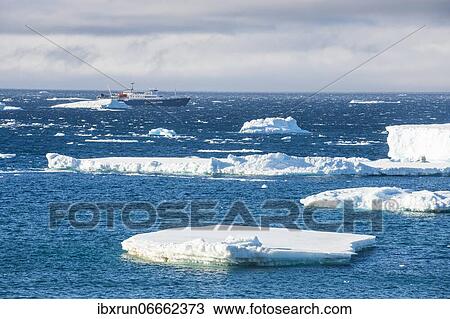 Stock Image - Cruise ship behind icebergs, Brown Bluff, Tabarin Peninsula, Antarctica. Fotosearch
