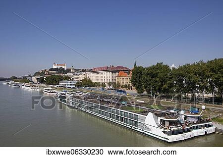 Stock Image - Cruise ship pier with view to Bratislava Castle, Danube, Bratislava, Slovakia, Europe. Fotosearch