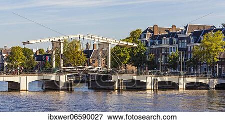 Stock Photo - Drawbridge Magere Brug, Dutchman's Bridge, River Amstel, Old Town, Amsterdam, Netherlands. Fotosearch