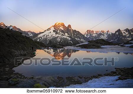 Evening atmosphere with alpenglow, water reflection in Lac Blanc, mountain peaks, Aiguille Verte, Grandes Jorasses, Aiguille du Moine, Mont Blanc, Mont Blanc massif, Chamonix-Mont-Blanc, Haute-Savoie, France, Europe View Large Photo Image Stock Image - Evening atmosphere with alpenglow, water reflection in Lac Blanc, mountain peaks, Aiguille Verte, Grandes Jorasses, Aiguille du Moine, Mont Blanc, Mont Blanc massif, Chamonix-Mont-Blanc, Haute-Savoie, France, Europe. Fotosearch