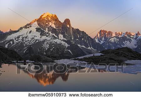 Evening atmosphere with alpenglow, water reflection in Lac Blanc, mountain peaks, Aiguille Verte, Grandes Jorasses, Aiguille du Moine, Mont Blanc, Mont Blanc massif, Chamonix-Mont-Blanc, Haute-Savoie, France, Europe View Large Photo Image Stock Image - Evening atmosphere with alpenglow, water reflection in Lac Blanc, mountain peaks, Aiguille Verte, Grandes Jorasses, Aiguille du Moine, Mont Blanc, Mont Blanc massif, Chamonix-Mont-Blanc, Haute-Savoie, France, Europe. Fotosearch