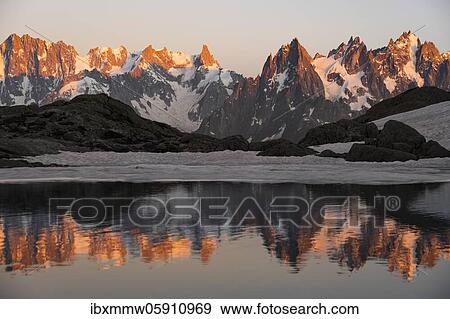 Evening atmosphere with alpenglow, water reflection in Lac Blanc, mountain peaks, Aiguille Verte, Grandes Jorasses, Aiguille du Moine, Mont Blanc, Mont Blanc massif, Chamonix-Mont-Blanc, Haute-Savoie, France, Europe View Large Photo Image Stock Photo - Evening atmosphere with alpenglow, water reflection in Lac Blanc, mountain peaks, Aiguille Verte, Grandes Jorasses, Aiguille du Moine, Mont Blanc, Mont Blanc massif, Chamonix-Mont-Blanc, Haute-Savoie, France, Europe. Fotosearch