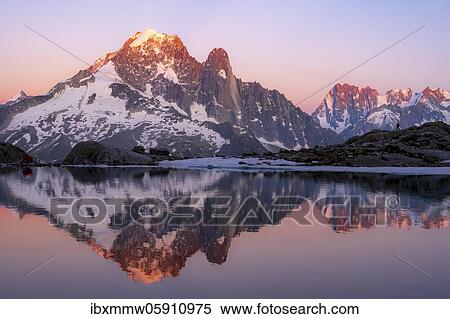 Stock Photography - Evening atmosphere with alpenglow, water reflection in Lac Blanc, mountain peaks, Aiguille Verte, Grandes Jorasses, Aiguille du Moine, Mont Blanc, Mont Blanc massif, Chamonix-Mont-Blanc, Haute-Savoie, France, Europe. Fotosearch