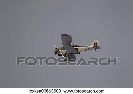 Stock Image - Fairey Swordfish aircraft in flight in Royal Navy markings, Cambridgeshire, England, United Kingdom, Europe. Fotosearch