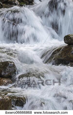 Flowing water at the Gössnitz waterfall in Hohe Tauern National Park, Austria, Europe View Large Photo Image Stock Photo - Flowing water at the Gössnitz waterfall in Hohe Tauern National Park, Austria, Europe. Fotosearch
