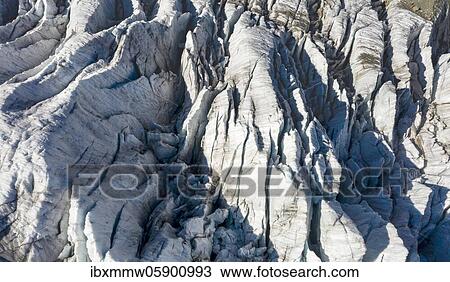 Stock Image - Glacier crevasses in summer, Upper sea of ice, High alpine landscape and glacier, Schreckhorn, Bernese Oberland, Switzerland, Europe. Fotosearch