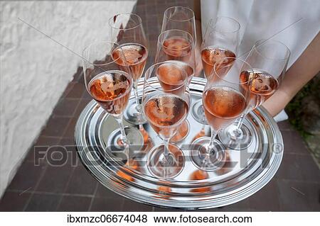 Stock Photo - Glasses of champagne served on a silver tray. Fotosearch