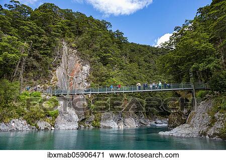 Stock Image - Hanging bridge at the Blue Pools rock pools, Makarora River, turquoise crystal clear water, Haast Pass, West Coast, South Island, New Zealand, Oceania. Fotosearch