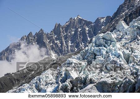 Stock Image - High alpine mountain landscape, glacier tongue, Glacier des Bossons, summit Aiguille du Midi, Chamonix, Haute-Savoie, France, Europe. Fotosearch