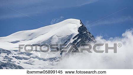Stock Photography - High alpine mountain landscape, summit Aiguille du Goûter with glacier, Glacier de Taconnaz, behind Mont Blanc, Chamonix, Haute-Savoie, France, Europe. Fotosearch