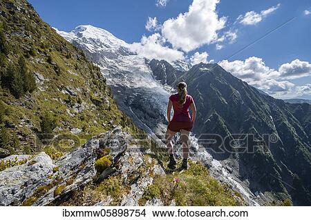 Hiker looking at mountain landscape, view of glacier Glacier de Taconnaz, hiking La Jonction, Chamonix, Haute-Savoie, France, Europe View Large Photo Image Picture - Hiker looking at mountain landscape, view of glacier Glacier de Taconnaz, hiking La Jonction, Chamonix, Haute-Savoie, France, Europe. Fotosearch
