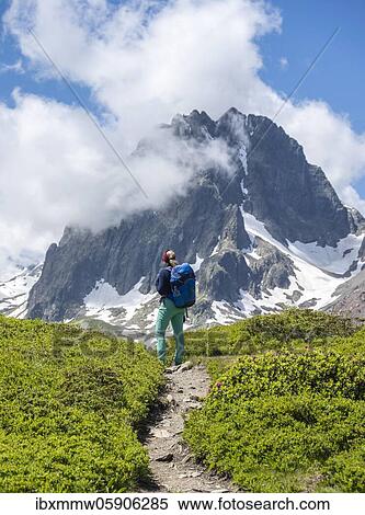 Hiker on a hiking trail, Aiguilette des Posettes, in the background mountain peaks Aiguille de Chamois and Aiguille de Praz-Torrent, Chamonix, Haute-Savoie, France, Europe View Large Photo Image Stock Photography - Hiker on a hiking trail, Aiguilette des Posettes, in the background mountain peaks Aiguille de Chamois and Aiguille de Praz-Torrent, Chamonix, Haute-Savoie, France, Europe. Fotosearch