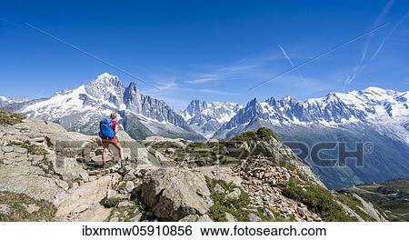 Hiker on hiking trail, Grand Balcon Sud, glacier, Mer de Glace, Aiguille Verte and Mont Blanc summits, Grandes Jorasses, Mont Blanc massif, Chamonix-Mont-Blanc, Haute-Savoie, France, Europe View Large Photo Image Stock Photograph - Hiker on hiking trail, Grand Balcon Sud, glacier, Mer de Glace, Aiguille Verte and Mont Blanc summits, Grandes Jorasses, Mont Blanc massif, Chamonix-Mont-Blanc, Haute-Savoie, France, Europe. Fotosearch