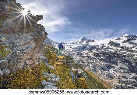 Stock Photograph - Hiker on trail to Glacier du Tour, glacier and mountain peak, high alpine landscape, Aiguille de Chardonnet, Chamonix, Haute-Savoie, France, Europe. Fotosearch