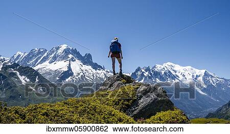 Hiker standing on rocks, mountain panorama from Aiguillette des Posettes, left summit of Aiguille Verte (right) Aiguille du Midi and Mont Blanc, Chamonix, Haute-Savoie, France, Europe View Large Photo Image Stock Image - Hiker standing on rocks, mountain panorama from Aiguillette des Posettes, left summit of Aiguille Verte (right) Aiguille du Midi and Mont Blanc, Chamonix, Haute-Savoie, France, Europe. Fotosearch