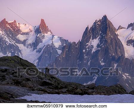 Hikers enjoy the view, evening mood with alpenglow, mountain panorama, mountain peaks, Grandes Jorasses and Mont Blanc massif, Chamonix-Mont-Blanc, Haute-Savoie, France, Europe View Large Photo Image Stock Photo - Hikers enjoy the view, evening mood with alpenglow, mountain panorama, mountain peaks, Grandes Jorasses and Mont Blanc massif, Chamonix-Mont-Blanc, Haute-Savoie, France, Europe. Fotosearch