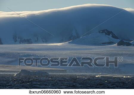 Stock Image - Huge clouds behind the glaciers on Tabarin Peninsula, Antarctica. Fotosearch