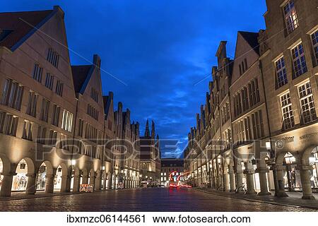 Stock Image - Illuminated historic gabled houses in the evening at blue hour, Prinzipalmarkt, Münster, North Rhine-Westphalia, Germany, Europe. Fotosearch