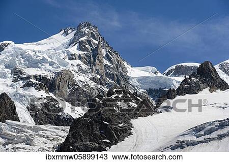 Stock Image - La Jonction, glacier tongue, Glacier des Bossons meets Glacier de Taconnaz, summit of Mont Maudit and Mont Blanc, Chamonix, Haute-Savoie, France, Europe. Fotosearch