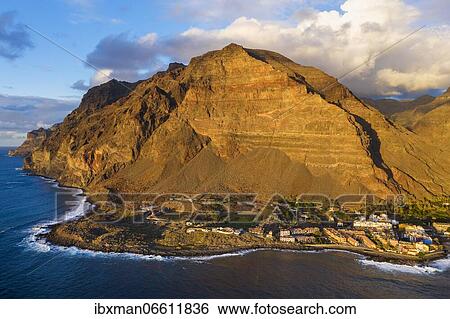 Stock Photograph - La Playa village, Riscos de la Merica mountain, Valle Gran Rey, drone recording, La Gomera, Canary Islands, Spain, Europe. Fotosearch