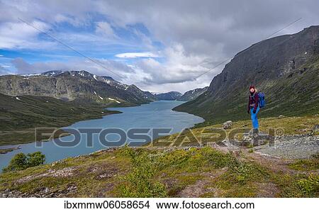Lake Gjende, hiker on the Besseggen hike, Jotunheimen National Park, Vågå, Innlandet, Norway, Europe View Large Photo Image Picture - Lake Gjende, hiker on the Besseggen hike, Jotunheimen National Park, Vågå, Innlandet, Norway, Europe. Fotosearch