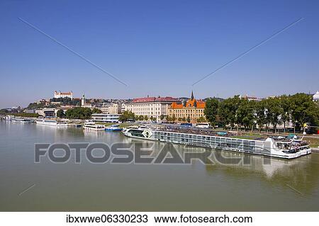 Stock Image - Landing stage for Danube cruise ships with a view to Bratislava Castle, Danube, Bratislava, Slovakia, Europe. Fotosearch