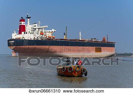 Little boat under a Huge container ship ready to break up, Chittagong Ship Breaking Yard, Chittagong, Bangladesh, Asia View Large Photo Image Stock Image - Little boat under a Huge container ship ready to break up, Chittagong Ship Breaking Yard, Chittagong, Bangladesh, Asia. Fotosearch