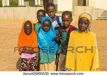 Stock Image - Local school children look at the camera, Niamey, Niger, Africa. Fotosearch