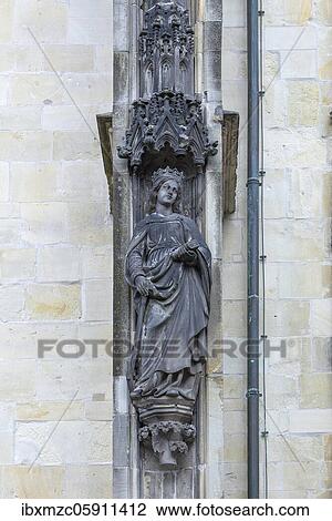 Martyr Catherine of Alexandria with wheel, sword and book, figure on the church facade of the Lambertikirche, Münster, North Rhine-Westphalia, Germany, Europe View Large Photo Image Stock Image - Martyr Catherine of Alexandria with wheel, sword and book, figure on the church facade of the Lambertikirche, Münster, North Rhine-Westphalia, Germany, Europe. Fotosearch
