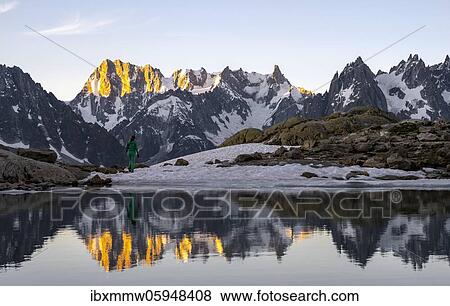 Morning atmosphere at sunrise, water reflection in Lac Blanc, mountain top, Aiguille Verte, Grandes Jorasses, Aiguille du Moine, Mont Blanc, Mont Blanc massif, Chamonix-Mont-Blanc, Haute-Savoie, France, Europe View Large Photo Image Stock Photo - Morning atmosphere at sunrise, water reflection in Lac Blanc, mountain top, Aiguille Verte, Grandes Jorasses, Aiguille du Moine, Mont Blanc, Mont Blanc massif, Chamonix-Mont-Blanc, Haute-Savoie, France, Europe. Fotosearch