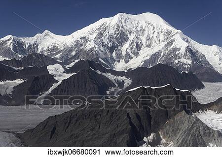 Stock Image - Mount Denali, aerial view of the south side of the peak, in front glaciated rock formations and Ruth Glacier, Denali National Park, Alaska, USA, North America. Fotosearch